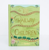 The Railway Children | Collector's Edition | Hardcover features a green cover with gold lettering, a winding railway track, a green train, hills, and colorful flowers. Authored by Edith Nesbit.