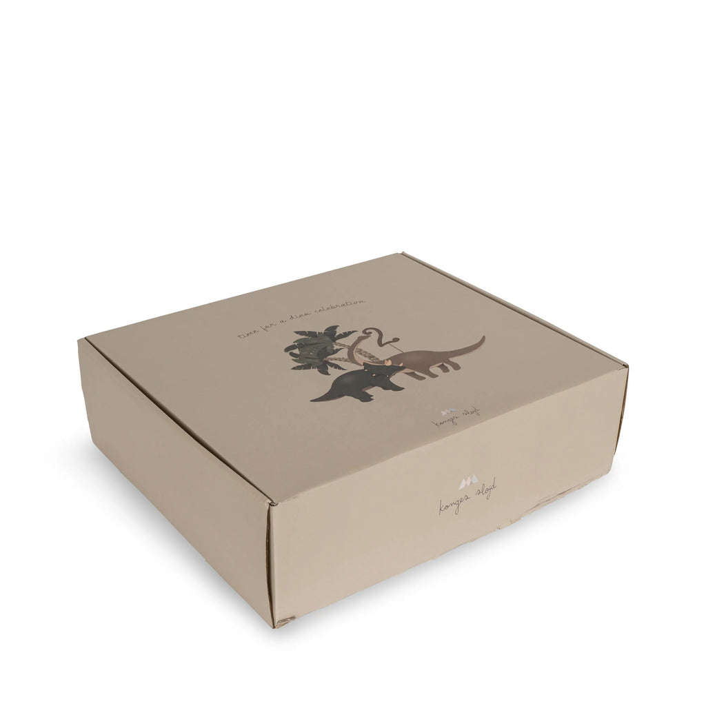 A Dinosaur Birthday Train With Beeswax Candles on a plain background features a dinosaur theme illustration and elegant script text. Its neutral, professional appearance is suitable for packaging.