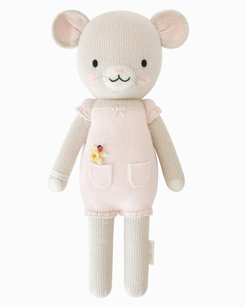 Cuddle + Kind Beatrice The Mouse - Blush is a handmade cotton yarn doll with light beige fur, dressed in a pale pink romper with pockets and floral details, shown standing upright against a white background.