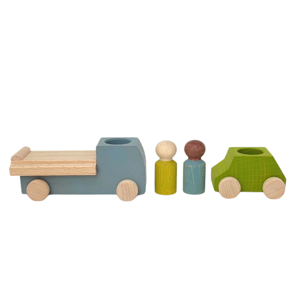 The Lubulona Wooden Tow Truck - Grey is a wooden toy set for small-world play, featuring a grey tow truck, a green car, and two peg figures with natural wood wheels and heads, shown in a row on a plain white background.