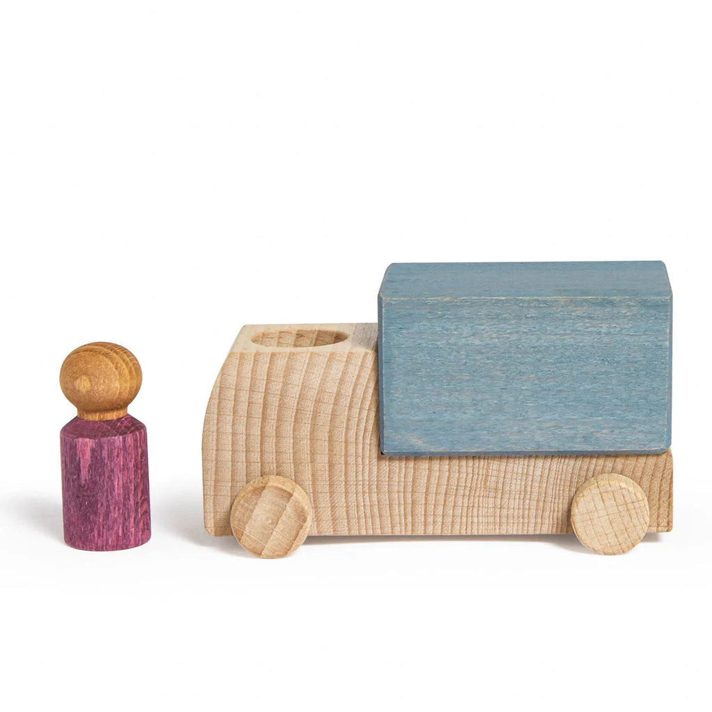 A Lubulona Wooden Truck - Grey with natural wood wheels and a blue block on its back sits beside a small purple peg figure, all from the charming Lubu Town collection, displayed on a white background.