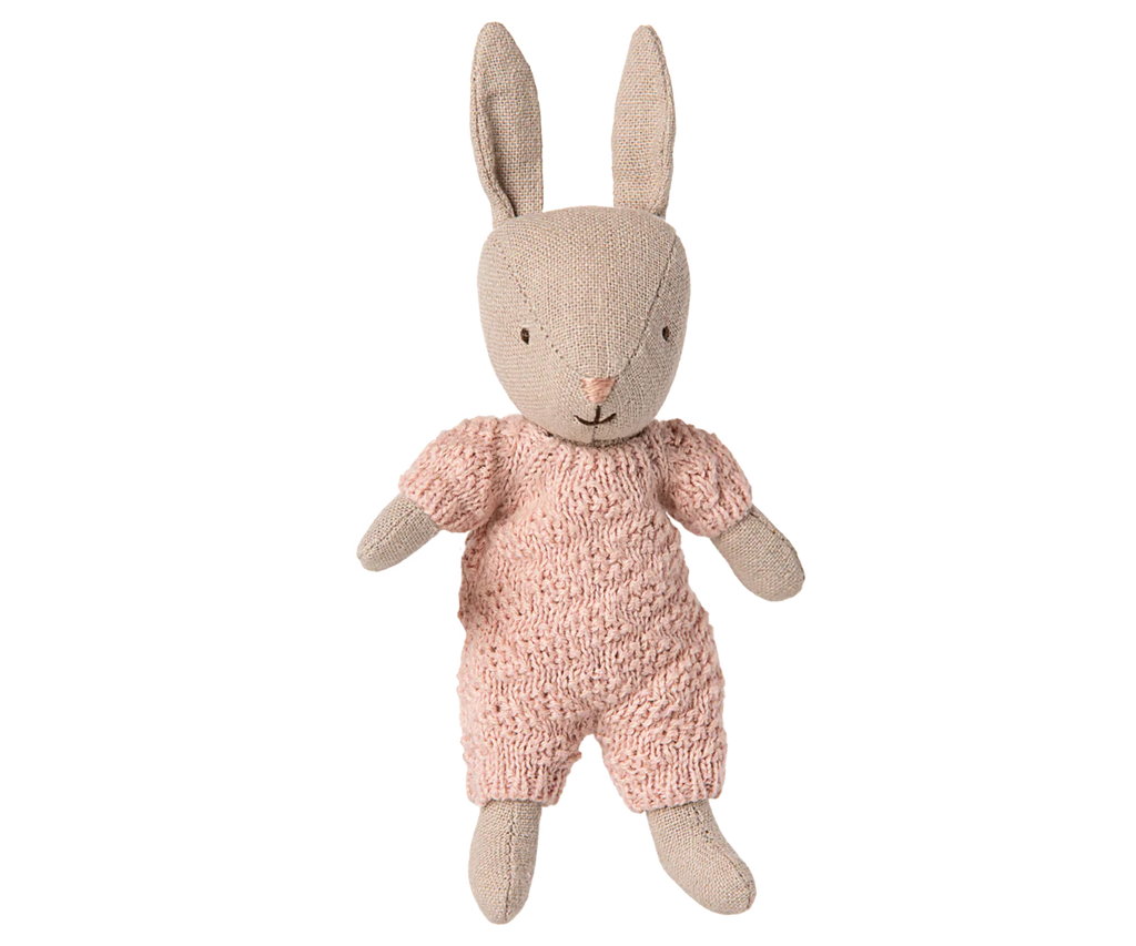 The PRE-ORDER: Rabbit Micro - Sand - Rose Knitted Suit features a soft rabbit with upright ears in a rose knit outfit, set against a striped background—ideal for Maileg accessories or the House of Miniature dollhouse. Ships early October.