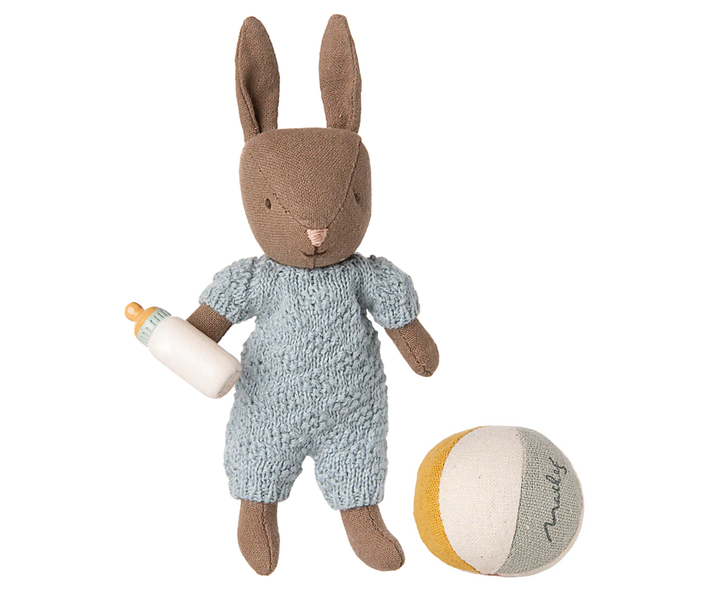 PRE-ORDER: Rabbit Set, Micro - Brown - Blue (ships early November). Features a plush bunny in a light blue knitted outfit holding a baby bottle, with a soft round toy ball in yellow, gray, and white.