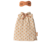 A nightgown for Mom Mouse by Maileg, featuring a small pink eye mask with closed-eye details and a beige drawstring pouch with orange polka dots—perfectly sized for your Maileg mouse family.