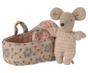 The PRE-ORDER: Baby Mouse in Carry Cot - Rose (Estimated Ship Date: Late October) features a small baby mouse in a pink and white knitted suit standing beside a fabric carry cot with blue and brown floral patterns and two handles.