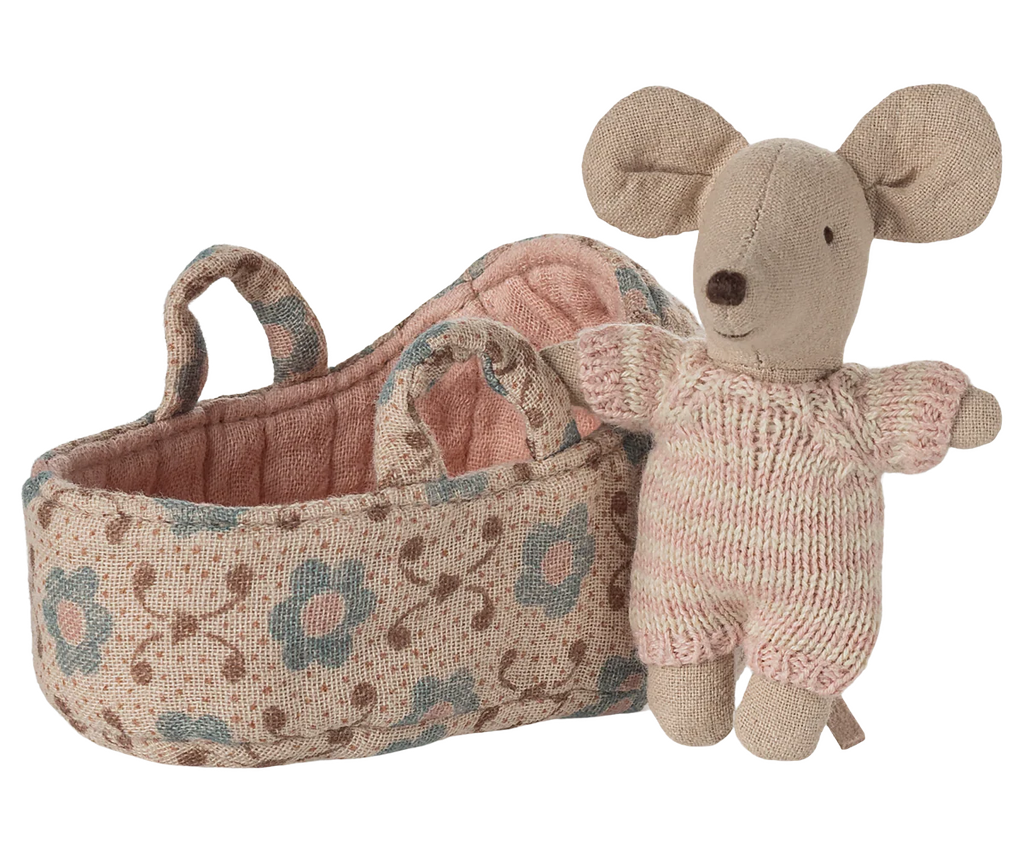 The PRE-ORDER: Baby Mouse in Carry Cot - Rose (Estimated Ship Date: Late October) features a small baby mouse in a pink and white knitted suit standing beside a fabric carry cot with blue and brown floral patterns and two handles.