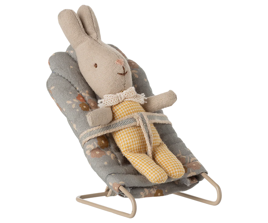 A stuffed bunny toy in a yellow checkered outfit sits secured in the PRE-ORDER: Babysitter, My - Blue baby bouncer (ships late September), featuring a lovely floral pattern.