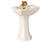 The PRE-ORDER: Bathroom Sink, Mouse Size - Off White (ships early October) features a gold faucet and handles, ideal for your SuitCasa bathroom, and is shown against a plain background.