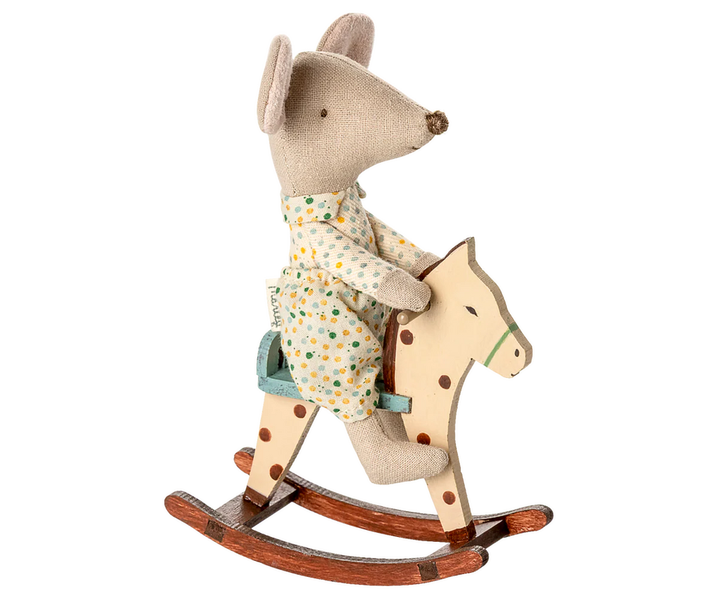 A gray mouse in polka-dot pajamas rides the PRE-ORDER: Rocking Horse, Mouse - Spotted, featuring a cream body with brown spots, green bridle, and metal handles. Approximate ship date: Early September.