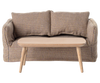 A small checkered sofa with two cushions and the PRE-ORDER: Coffee Table, Mouse - Nature (ships early October) in front, set against a plain backdrop, creates the perfect Mouse hole Farmhouse vibe.