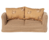 The PRE-ORDER: Couch, Mouse - Mable (ships early August) features a compact plaid design with two large floral cushions in light brown and beige—ideal for cozy charm in a Mouse hole Farmhouse living room beside a wooden coffee table.