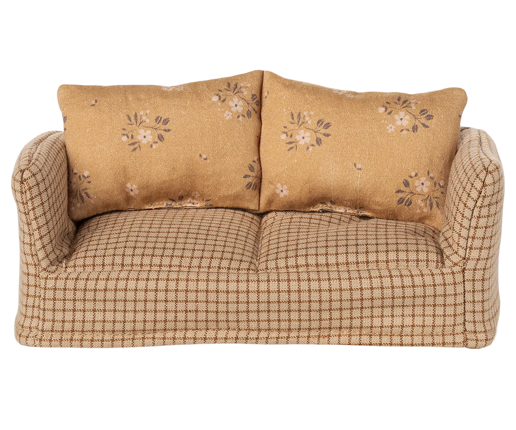 The PRE-ORDER: Couch, Mouse - Mable (ships early August) features a compact plaid design with two large floral cushions in light brown and beige—ideal for cozy charm in a Mouse hole Farmhouse living room beside a wooden coffee table.