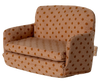The PRE-ORDER: Sofa Bed, Mouse - Dots (ships late September) features tan upholstery with orange polka dots and padded arms and backrest—perfect for a cozy SuitCasa living room. Shown angled.