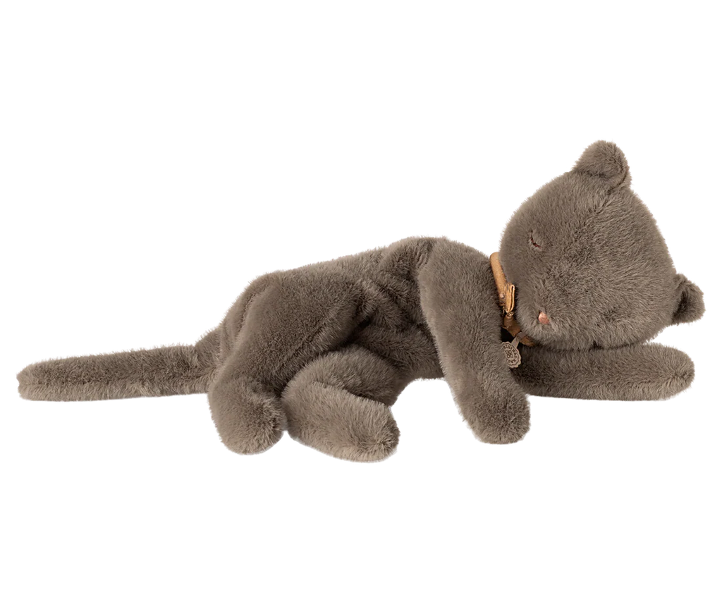 The PRE-ORDER: Sleeping Kitten Plush, Medium - Grey (Estimated Ship Date: Late November) is a soft, fuzzy plush made from recycled polyester. It lies on its side with closed eyes, a long tail, and wears a small brown ribbon around its neck.