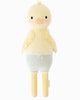 Cuddle + Kind Duckling is a cute, handmade yellow knit plush with a round head, blush cheeks, soft wings, long legs, pale blue and white striped shorts with a pink bow, and hypoallergenic polyfill stuffing.
