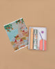 A flat lay of the Diamond Painting Kit - Positano by Petra Lidze on a tan background, featuring a colorful canvas of houses and trees, bags of gems, and all tools neatly arranged in an open box.