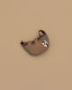 The Donsje Leather Talei Bumbag Purse - Sloth is a small, brown and gray kids bag shaped like a smiling sloth, featuring an adjustable strap, shown on a plain beige background.