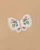 The Meri Meri Butterfly Wings feature ruffled edges and vibrant embroidered flowers on the wings, set against a plain beige background.