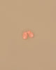 A pair of Minikane Beach Sandals in peach are placed side by side on a plain beige background.