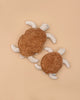 Two Senger Naturwelt Cuddly Animal Turtles, one large and one small, with brown shells and light flippers, rest on a plain beige background. Made from organic cotton and inspired by Senger Naturwelt's heat pad design.