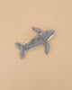 The Senger Naturwelt Cuddly Animal - Whale, a gray plush toy with a white underside made from organic cotton, is displayed on a plain beige background.