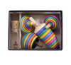 The Mader Spinning Top Champion Learning Set - Striped includes four colorful striped tops in different sizes and a small glass vial with a mini spinning top inside. Contains small parts; choking hazard—meets toy safety standards.