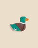 The Holztiger Mallard Duck, Sitting is a handcrafted wooden figurine featuring a green head, orange beak, brown chest, and blue-white wing spot. Ships in one week. Shown on a plain beige background.