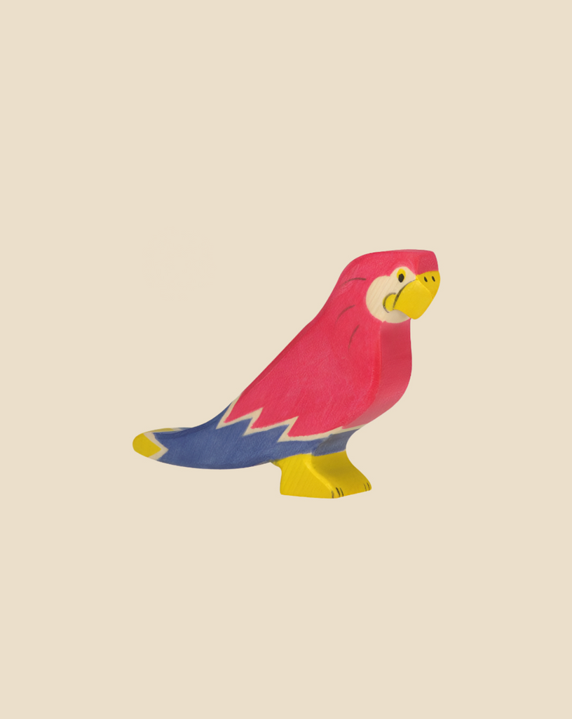 The Holztiger Parrot, a colorful handcrafted wood toy painted pink, blue, yellow, and white, stands on a light beige background. Made in Europe, this charming figure ships in one week and is part of the HOLZTIGER collection.