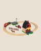 The BRIO World Train Set Farm Railway Set includes a circular track, red barn, tractor, cow, fences, magnetic train carriages, and a crossing sign—ideal for imaginative play.