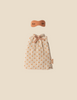A small beige Maileg Extra Clothing: Nightgown For Mom Mouse, with orange polka dots and a bow at the neck, plus a matching orange nightgown-style eye mask with embroidered closed eyes, displayed on a plain beige background.