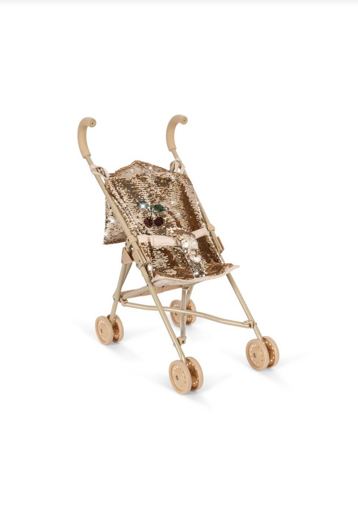 The Konges Sloejd Sparkly Sequin Doll Stroller - Golden Cherry features a stylish gold color, curved handles, a shiny sequined seat, and four pairs of wheels, shown against a plain white background.