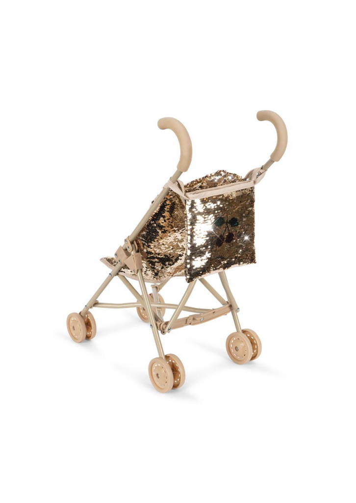 The Konges Sloejd Sparkly Sequin Doll Stroller - Golden Cherry, with beige handles and wheels plus a shiny gold sequin seat and backrest, is displayed on a plain white background.