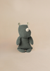The Maileg Small Rhino - Pine is a gray stuffed animal with a white horn, floral inner ears, and a minimalist design made from soft fabric, shown sitting against a plain beige background.