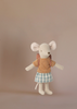 A Maileg Afternoon Tea With Grandma And Grandpa set features the Big Sister mouse with a yellow and orange striped shirt, blue and white checkered skirt, and pink backpack against a plain beige background.
