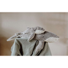 Two Senger Naturwelt Cuddly Animal - Whale toys, one large and one small, rest on a green textured blanket. Handmade in Germany from organic cotton, they're an adorable and eco-friendly addition to any cozy space.