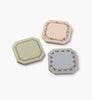 The Gemma Mini Notepad Trio features three decorative octagonal notepads in pastel pink, green, and blue with metallic gold details and floral borders. Each notepad includes convenient tear-off sheets and is displayed on a white background.