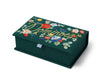 The Strawberry Fields Dominoes Set is a dark green embroidered keepsake box featuring colorful illustrations and "Dominoes" stitched in yellow cursive on the lid, with a light blue ribbon tab on the front.