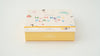 A pastel-colored box labeled "Magnetic Number Play Set" for ages 3+, features playful numbers and shapes on a white background—ideal to combine with wooden toys or alphabet cards for early learning fun.
