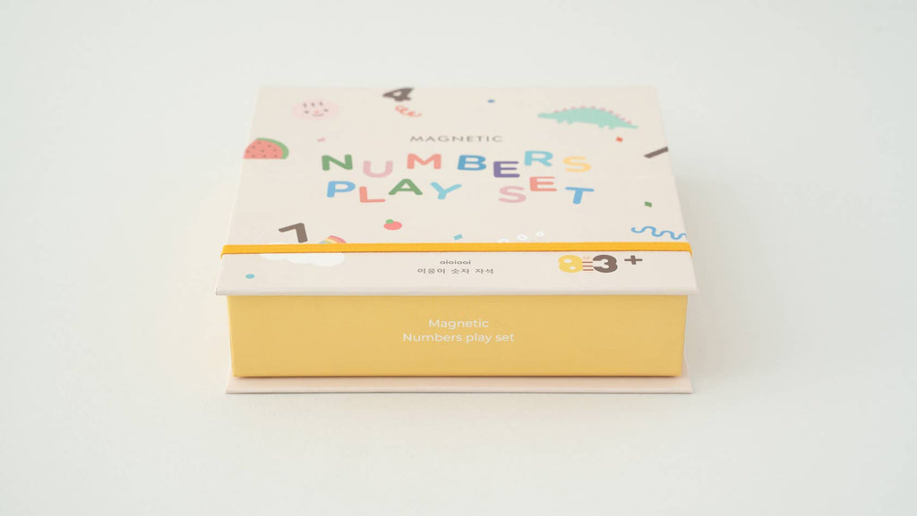A pastel-colored box labeled "Magnetic Number Play Set" for ages 3+, features playful numbers and shapes on a white background—ideal to combine with wooden toys or alphabet cards for early learning fun.