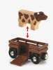 A wooden toy cow hovers above a brown trailer with an open ramp. A red double-headed arrow shows the cow can go inside—perfect for imaginative play with your BRIO World Train Set Farm Railway Set.