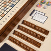 The 3-in-1 Game Collection features a Scrabble board with four tile racks (“ARGEN,” “FRIENDO,” “DATENI,” “LAX WORD”) plus Trivial Pursuit cards, dice, and pie tokens for extra fun at the table.