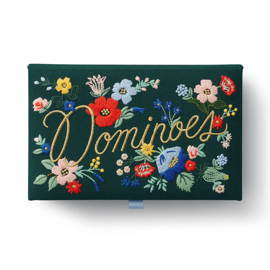 A dark green embroidered keepsake box with colorful flowers, featuring “Strawberry Fields Dominoes Set” stitched in yellow cursive across the center.