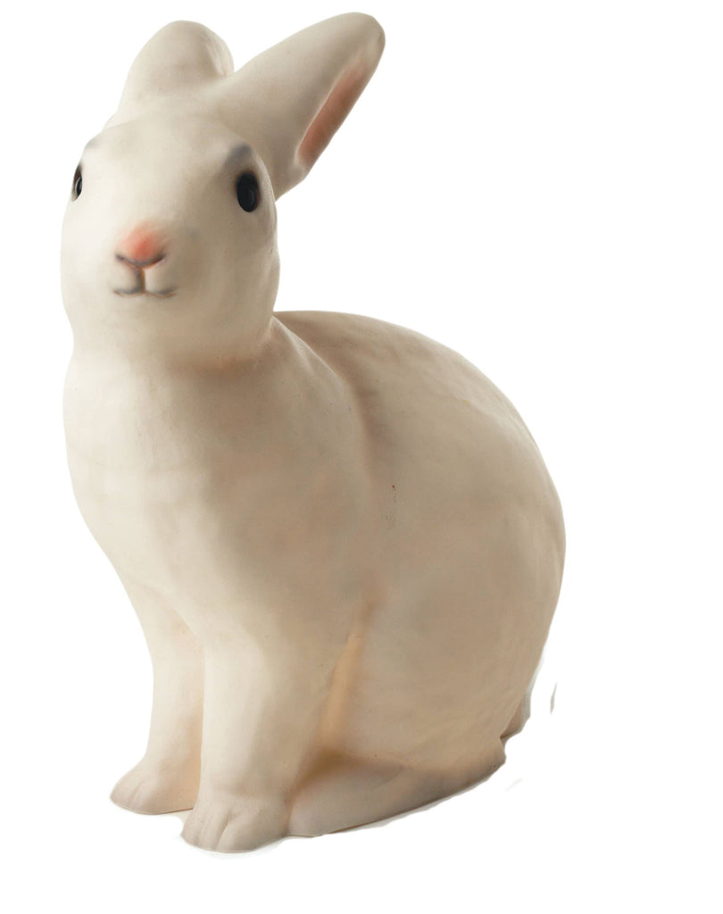The White Bunny Lamp features a lifelike, white chocolate-colored bunny sculpture with pink inner ears and a pink nose, sitting upright—an ideal whimsical night light for children's rooms or nurseries.