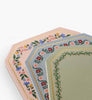 The Gemma Mini Notepad Trio features three decorative notepads with scalloped edges, metallic gold details, and pastel pink, blue, and green floral-bordered pages stacked on a white background.