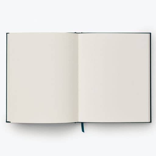 The Strawberry Fields Embroidered Sketchbook, featuring blank white pages and a blue ribbon bookmark, is open on a plain light background.