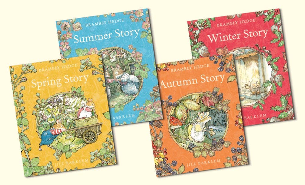 A Year In Brambly Hedge by Jill Barklem features four classic children's stories, each named for a season—Spring, Summer, Autumn, and Winter—with illustrated covers showing detailed animal scenes.