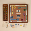 A top-down view of the 3-in-1 Game Collection: Monopoly, Sorry & Mancala displays colorful pawns, a mancala tray, Monopoly money, dice, cards, and game pieces—all neatly arranged for your game cabinet.