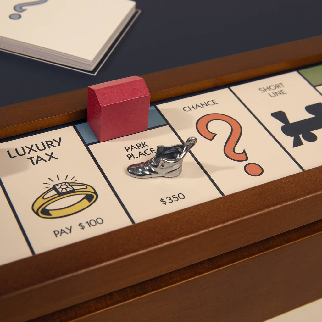 A close-up of the 3-in-1 Game Collection: Monopoly, Sorry & Mancala board features Park Place, Chance, and Luxury Tax spaces with a red hotel and shoe token on Park Place—an ideal addition to any game cabinet.