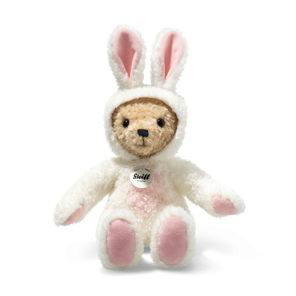 The Steiff Teddy Bear with Bunny Hoodie Costume (11 Inches) features a white bunny outfit with pink ears and paws, a round brown face, and a signature Steiff tag—an adorable zodiac charm for celebrating Chinese New Year’s rabbit. White background.