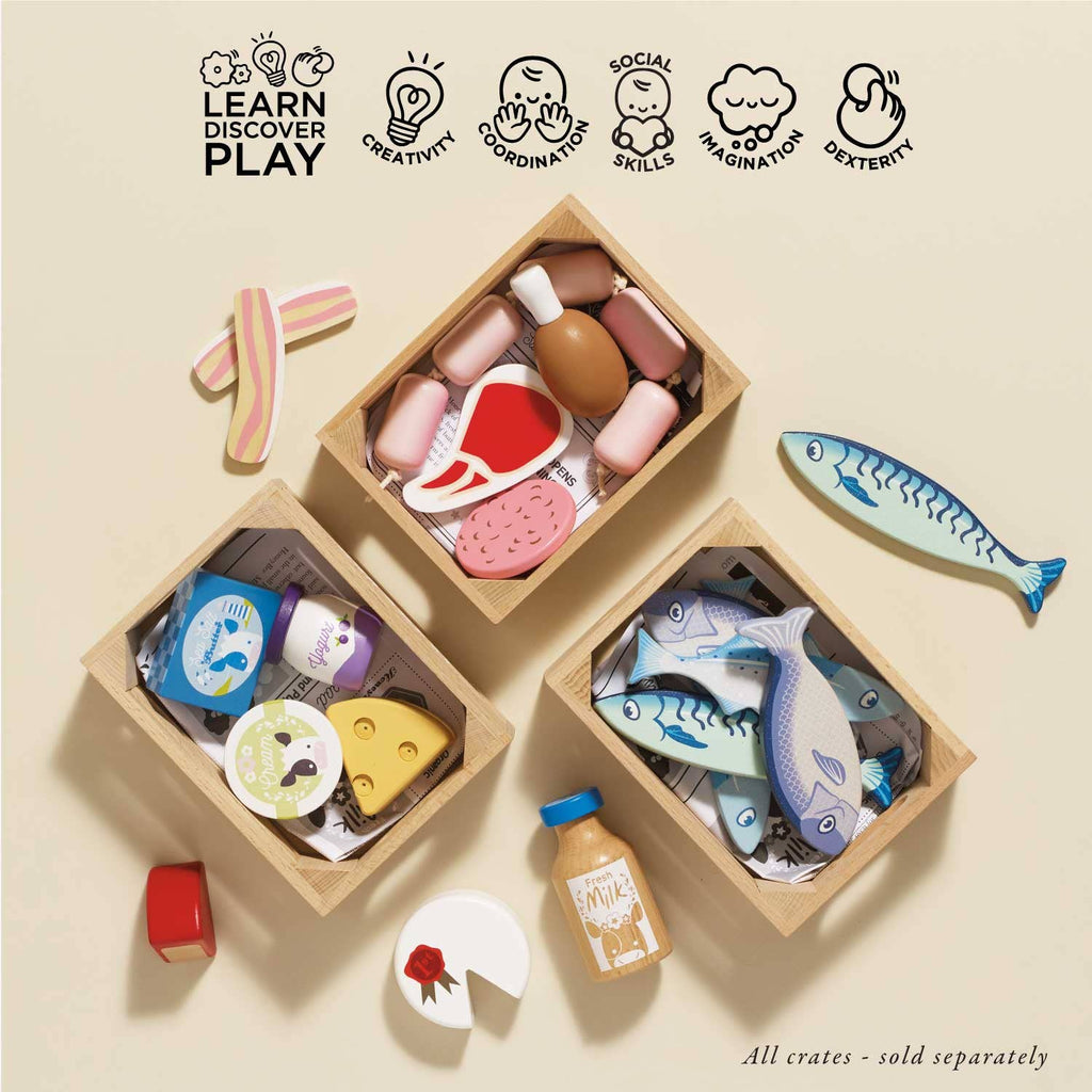 The Farm Eggs Wooden Market Crate features colorful pretend-play items like fish, cheese, eggs, milk, and fruit. Icons highlight creativity, coordination, social skills, imagination, and dexterity. Crates sold separately.